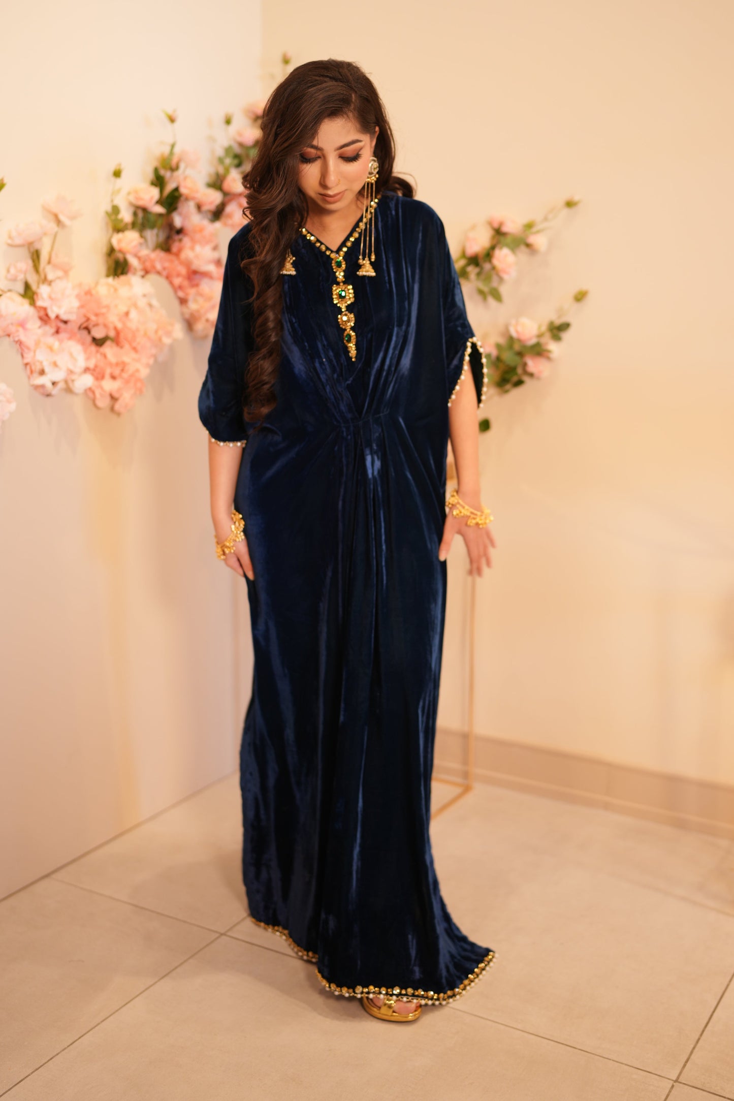 Navy blue velvet kaftan with V neckline cinched waist and embellishment